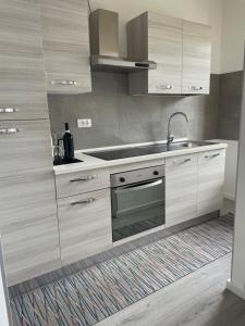 a kitchen with wooden cabinets and a sink at Domus de Silvi in Silvi Marina