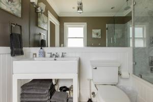 a bathroom with a sink and a toilet and a mirror at Iconic Modern Farmhouse in San Luis Obispo +27 photos