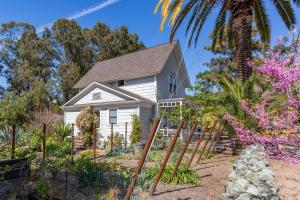 a house on the beach with a palm tree at Iconic Modern Farmhouse in San Luis Obispo
