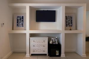 a living room with a tv on a wall at 18 On OniX - World Class in Four Ways