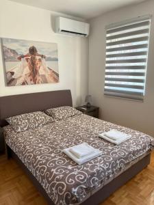 a bedroom with a bed with two towels on it at Apartment Varezić in Plužine