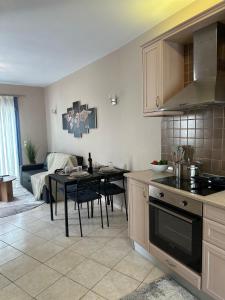 a kitchen and living room with a table and a couch at Kaloula's home in Keramoto