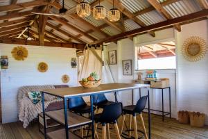 a kitchen with a table and chairs in a room at Tootila in Sainte-Rose