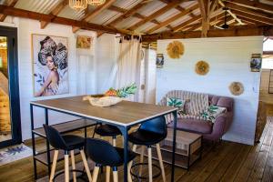 a dining room with a table and chairs at Tootila in Sainte-Rose +27 photos