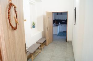 a hallway with a door leading to a room with a kitchen at Apartment Porta in Terezín