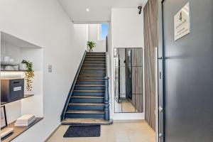 a staircase in a house with a blue railing at Sonnenblick Bregenz in Bregenz