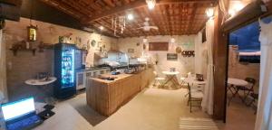 a kitchen with a counter and two tables in a room at Pousada Mirante Fonte Sônia in Valinhos