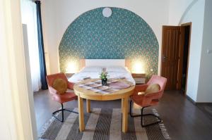 a bedroom with a table and chairs and a bed at Apartment Porta in Terezín