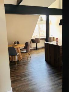 a kitchen and dining room with a table and chairs at Ferienwohnung Weitblick in Guxhagen +6 photos