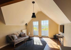 a living room with a couch and a large window at Ferienwohnung Weitblick in Guxhagen