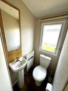 a small bathroom with a toilet and a sink at Atlantic 63 in Bude +34 photos