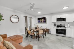 a kitchen and living room with a table and chairs at Bayview Regency Apartments By Lowkl in Fort Lauderdale