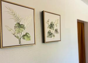 two framed pictures of plants on a wall at Happy Hill Inn in Kailua-Kona +30 photos