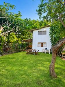 a yard with a picnic table and a house at Casa Medrado in Porto Seguro