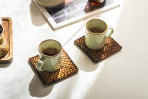 two cups of coffee sitting on top of waffles at Summer Villa in Adamantas