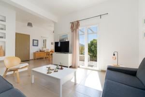 a living room with a couch and a table at Summer Villa in Adamantas