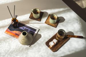 a group of vases and a table with a plate of food at Summer Villa in Adamantas