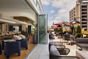 a patio with tables and chairs on a building at InterContinental Indianapolis by IHG in Indianapolis