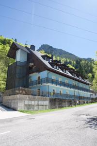 a large building on the side of a road at Casa Azzurra - Spacious apartment in the heart of Julian Alps in Cave del Predil
