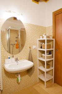 a bathroom with a sink and a mirror at Casa Azzurra - Spacious apartment in the heart of Julian Alps in Cave del Predil +27 photos