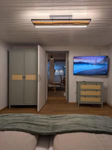 a living room with a flat screen tv on the ceiling at Lindo - Historisches Hof-Juwel in Schützen am Gebirge