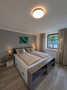 a bedroom with a large bed and a window at Lindo - Historisches Hof-Juwel in Schützen am Gebirge