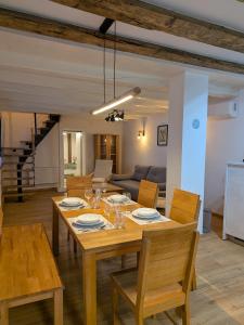 a dining room with a wooden table and chairs at Lindo - Historisches Hof-Juwel in Schützen am Gebirge