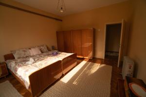 a bedroom with a bed and a wooden cabinet at Smestaj Vanja in Arilje