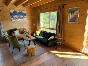 a living room with a couch and a table at Chalet cosy avec vue montagne proche La Clusaz & Le Grand-Bornand in Saint-Jean-de-Sixt +26 photos