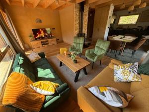 a living room with a couch and a table at Chalet cosy avec vue montagne proche La Clusaz & Le Grand-Bornand in Saint-Jean-de-Sixt