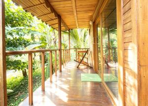 a wooden porch of a house in the jungle at ECO-POR in Rio do Ouro