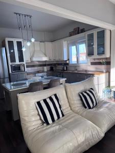 a living room with a white couch in a kitchen at SugarV Home in Kilkis +17 photos