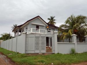 a white house with a fence in front of it at Casa del Zanzibar in Zanzibar City
