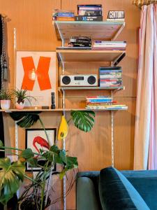 a living room with a couch and a book shelf at Woodside Studio in Hassocks