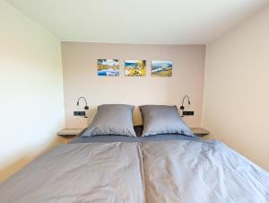 a bedroom with a bed with two pillows at Ferienwohnung MoselVino in Lieser