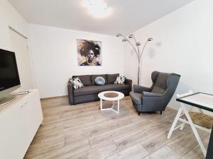 a living room with a couch and two chairs at Apartment Sia in Jadranovo