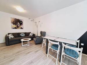 a living room with a couch and a table at Apartment Sia in Jadranovo +16 photos