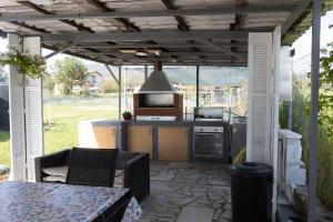an outdoor kitchen with a grill and a stove at Lanari Valley House in Thermi