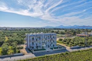 an aerial view of a white building in a field at Aurelea Luxury Apartments in Kos