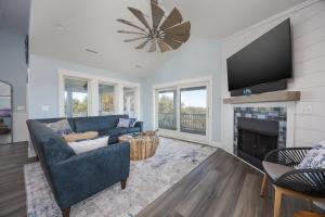 a living room with a blue couch and a fireplace at 2934 - Seas the Day in Duck