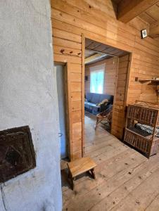 a living room with a couch in a wooden cabin at Chata leśna u Górala in Stróża