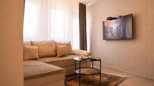 a living room with a couch and a table at Enzo's Apartments Prishtina in Prishtinë