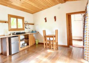 a kitchen with wooden floors and a table and chairs at ECO-POR in Rio do Ouro +30 photos