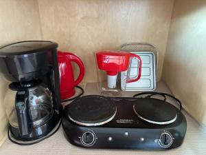 a coffeemaker and coffee maker sitting on a counter at Happy Hill Inn in Kailua-Kona