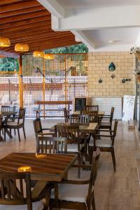 a dining room with wooden tables and chairs at Tunan Motel in Ayvalık