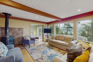 a living room with a couch and a fireplace at Shore Thing Retreat in Eastsound