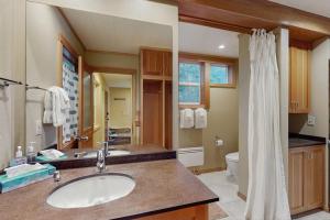 a bathroom with a sink and a toilet at Shore Thing Retreat in Eastsound +27 photos