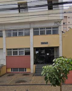 a building with a garage and a sign on it at Ap Aconchego in Campinas