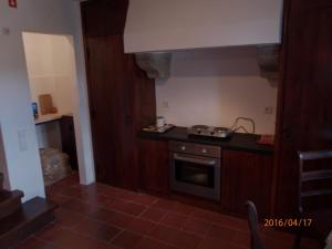 a kitchen with a stove and a counter top at Casa do Castelo - Óbidos in Óbidos +22 photos