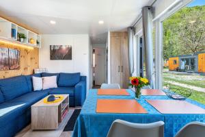 a living room with a blue couch and a table at Haus Lotte und Frieda in Riedenburg